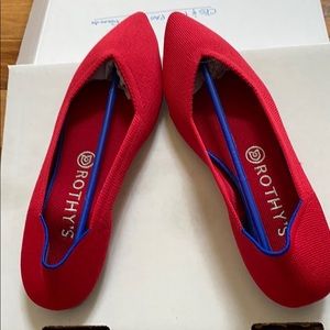 Not-real pointed toward red Rothy’s flats